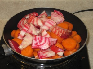 Beets and carrots sliced into a skillet 2